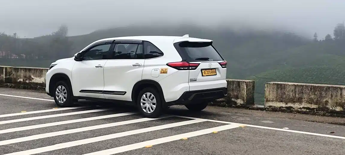 Kerala Taxis Hycross driving on Munnar mountain road